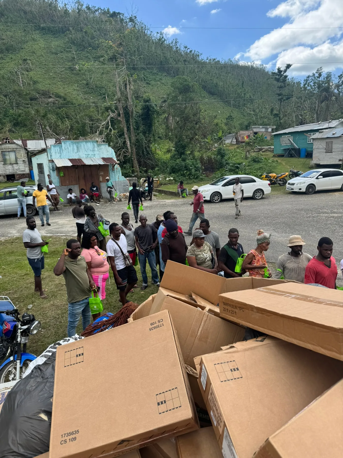 Neighbors gathering during a Project Grateful Hearts distribution in Jamaica