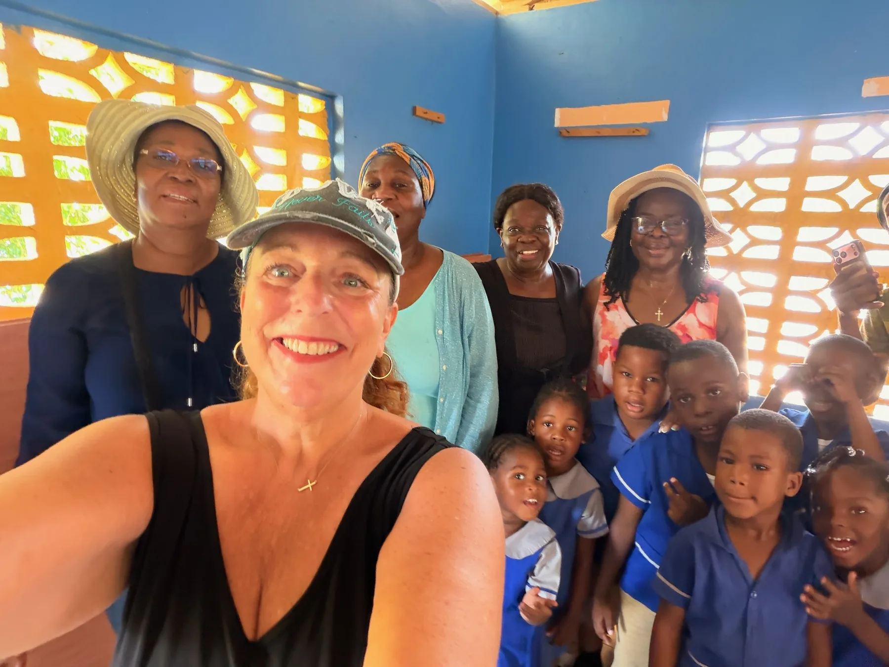 Project Grateful Hearts founder Kat Weir with women and children during community outreach in Jamaica