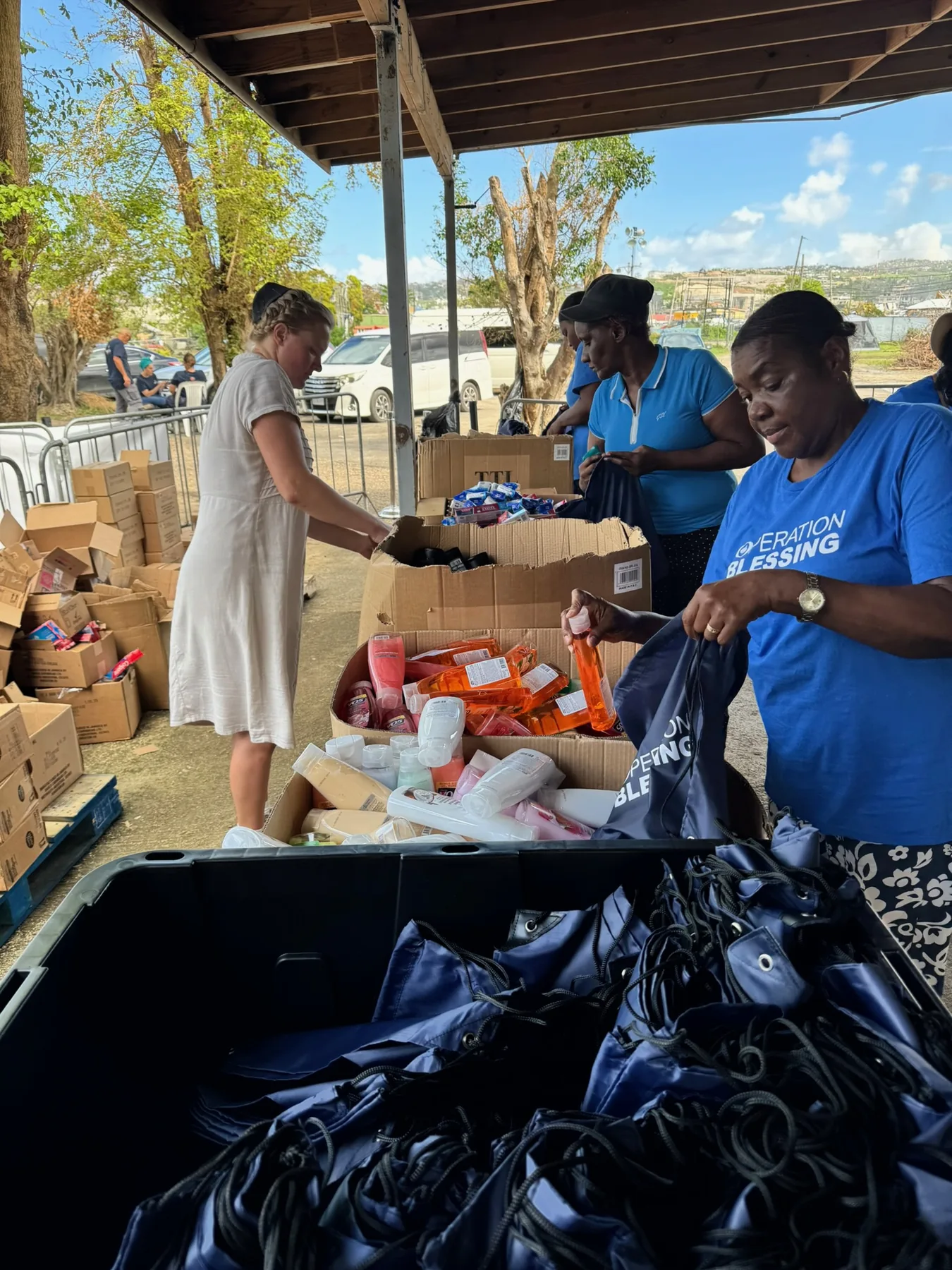 Volunteers packing hygiene and essential supplies for community distribution